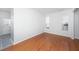 Vacant bedroom with hardwood floors, two bright windows, and a view of the entry and staircase at 137 St Phillips Row, Summerville, SC 29485