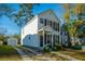 Well-maintained two-story residence with a cozy front porch, a long driveway, and a detached garage in the back at 137 St Phillips Row, Summerville, SC 29485
