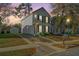 Two-story home with a wide driveway, manicured front yard, and a detached garage on the property at 137 St Phillips Row, Summerville, SC 29485