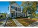 Attractive home showcasing a symmetrical facade with black shutters, a covered porch, and a long driveway at 137 St Phillips Row, Summerville, SC 29485