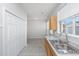 Corner of a kitchen featuring a double sink, wood cabinets, and a view to the backyard at 137 St Phillips Row, Summerville, SC 29485