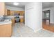 Open kitchen with wooden cabinets, stainless steel appliances, and access to living room at 137 St Phillips Row, Summerville, SC 29485