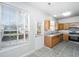 Bright kitchen with a window and door to backyard, wood cabinets, and stainless steel appliances at 137 St Phillips Row, Summerville, SC 29485