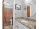 Clean bathroom featuring granite counters and a shower with patterned shower curtain at 14 Town Park Ln # B, Charleston, SC 29412