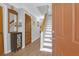 Bright foyer with hardwood floors, a decorative mirror, and stairs leading to the upper level at 14 Town Park Ln # B, Charleston, SC 29412