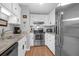 Modern kitchen with stainless steel appliances, bright white cabinets, and granite counters at 14 Town Park Ln # B, Charleston, SC 29412