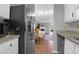 Well-lit kitchen with stainless steel appliances, granite countertops, and a view into the living room at 14 Town Park Ln # B, Charleston, SC 29412