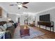 Comfortable living room featuring a ceiling fan, ample seating, and view to kitchen at 14 Town Park Ln # B, Charleston, SC 29412
