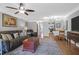 Comfortable living room featuring a ceiling fan, ample seating, and view to kitchen at 14 Town Park Ln # B, Charleston, SC 29412