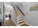 Staircase with wooden railing and white risers leads to the upper level of the home at 14 Town Park Ln # B, Charleston, SC 29412