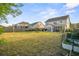 Large backyard with a well-maintained lawn, a view of the home's exterior, and a fenced garden area at 1529 Fishbone Dr, Johns Island, SC 29455