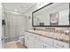 Bathroom featuring a spacious vanity with granite counters, framed mirror, and shower with patterned curtain at 1529 Fishbone Dr, Johns Island, SC 29455
