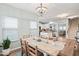 Bright dining room with views to kitchen and living room, featuring wood floors, and modern light fixture at 1529 Fishbone Dr, Johns Island, SC 29455