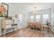 Dining area with wooden table and chairs complemented by natural light and decor; access to backyard at 1529 Fishbone Dr, Johns Island, SC 29455