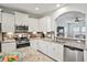 Well-equipped kitchen with granite countertops, stainless steel appliances, white cabinetry, and a stylish tile backsplash at 1529 Fishbone Dr, Johns Island, SC 29455