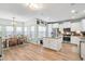 Open-concept kitchen with granite countertops, stainless steel appliances, island, and a seamless flow into the dining area at 1529 Fishbone Dr, Johns Island, SC 29455