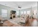 Inviting living room with stone fireplace, ceiling fan, hardwood floors and comfortable seating creates a relaxing atmosphere at 1529 Fishbone Dr, Johns Island, SC 29455