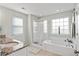 Bright bathroom with a granite countertop, glass shower, and a jacuzzi tub at 1529 Fishbone Dr, Johns Island, SC 29455