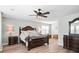 Spacious main bedroom with dark wood furniture, ceiling fan, and an ensuite bathroom at 1529 Fishbone Dr, Johns Island, SC 29455