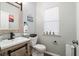 Charming powder room with a rustic wood frame mirror and beach themed decor at 1529 Fishbone Dr, Johns Island, SC 29455