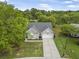 An aerial view of a home in a wooded neighborhood with a driveway and a lush lawn at 1537 Sweet Myrtle Cir, Mount Pleasant, SC 29466