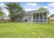 Large, lush backyard featuring a screened porch, patio area, and grassy area for relaxing at 1537 Sweet Myrtle Cir, Mount Pleasant, SC 29466