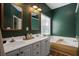 Green bathroom with double sink vanity, bathtub, and natural light at 1537 Sweet Myrtle Cir, Mount Pleasant, SC 29466