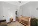 Bright Bedroom with crib, modern lighting, and a comfortable seating area for relaxation at 1537 Sweet Myrtle Cir, Mount Pleasant, SC 29466