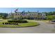 Stately clubhouse with American flag flying over manicured lawn and roundabout entryway at 1537 Sweet Myrtle Cir, Mount Pleasant, SC 29466