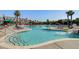 Community pool with shallow water entry, slide, and many lounge chairs by the pool's edge at 1537 Sweet Myrtle Cir, Mount Pleasant, SC 29466