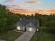 An evening view of a well-maintained single Gathering home with attached garage at 1537 Sweet Myrtle Cir, Mount Pleasant, SC 29466