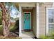 Inviting front porch with a teal door and decorative wreath at 1537 Sweet Myrtle Cir, Mount Pleasant, SC 29466