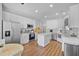 Bright kitchen with white cabinets, stainless steel appliances, and a center island on wood floor at 1537 Sweet Myrtle Cir, Mount Pleasant, SC 29466