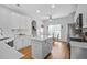 Open kitchen featuring white cabinets, a center island, wood floors, and an adjacent dining area at 1537 Sweet Myrtle Cir, Mount Pleasant, SC 29466
