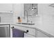 Close-up of a kitchen sink with subway tile backsplash, stainless steel faucet, and white countertops at 1537 Sweet Myrtle Cir, Mount Pleasant, SC 29466