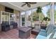 Cozy screened-in porch featuring comfortable lounge seating, a ceiling fan, and an outdoor fire pit at 1537 Sweet Myrtle Cir, Mount Pleasant, SC 29466