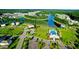 An aerial view showcases a community pool, lake, and lush landscaping within a well-designed neighborhood at 154 Calm Water Way, Summerville, SC 29486