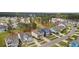 An aerial view captures the neighborhood's charming homes, tree-lined streets, and meticulously manicured lawns at 154 Calm Water Way, Summerville, SC 29486