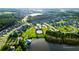 An aerial view showcases a community pool, lake, and lush landscaping within a well-designed neighborhood at 154 Calm Water Way, Summerville, SC 29486