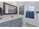 Bathroom with granite countertop, gray cabinets and a framed mirror at 154 Calm Water Way, Summerville, SC 29486
