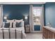 Inviting blue bedroom with a comfortable bed, soft lighting, and scenic views from the window at 154 Calm Water Way, Summerville, SC 29486