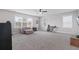 Spacious bonus room featuring a ceiling fan, plush carpeting, and plenty of natural light at 154 Calm Water Way, Summerville, SC 29486