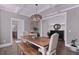 Charming dining room featuring wood table, modern lighting fixture, and shiplap accent wall at 154 Calm Water Way, Summerville, SC 29486