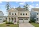 Charming two-story home featuring a welcoming front porch and a two-car garage at 154 Calm Water Way, Summerville, SC 29486