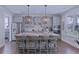 Well-lit kitchen features a large island, stainless steel appliances, and wooden barstools at 154 Calm Water Way, Summerville, SC 29486