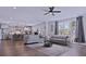 Open-concept living room featuring hardwood floors, comfortable seating, and natural light at 154 Calm Water Way, Summerville, SC 29486