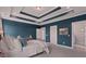 Spacious main bedroom featuring a tray ceiling, blue walls, and ensuite bathroom at 154 Calm Water Way, Summerville, SC 29486