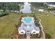 An aerial view shows the pool and club house amenities as well as well-manicured landscaping at 154 Calm Water Way, Summerville, SC 29486