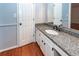 Bathroom featuring vanity with granite top, mirror, toilet and wood floors at 1561 Montclair St, Charleston, SC 29407