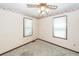 Modest-sized bedroom with carpet, two windows, wallpaper border, and ceiling fan at 1561 Montclair St, Charleston, SC 29407